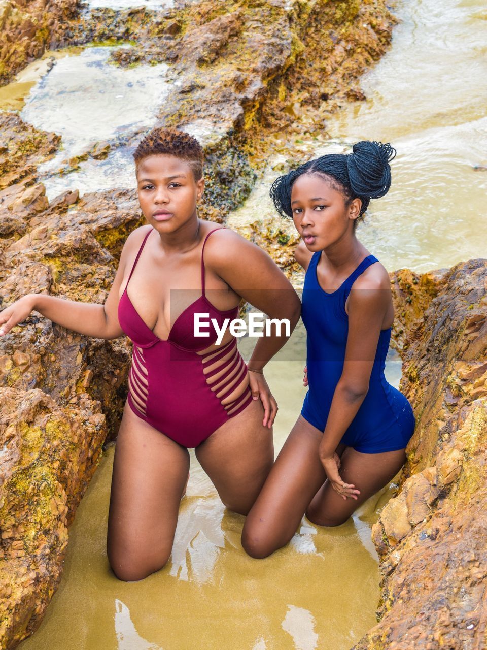 Portrait of teenage girls standing in water