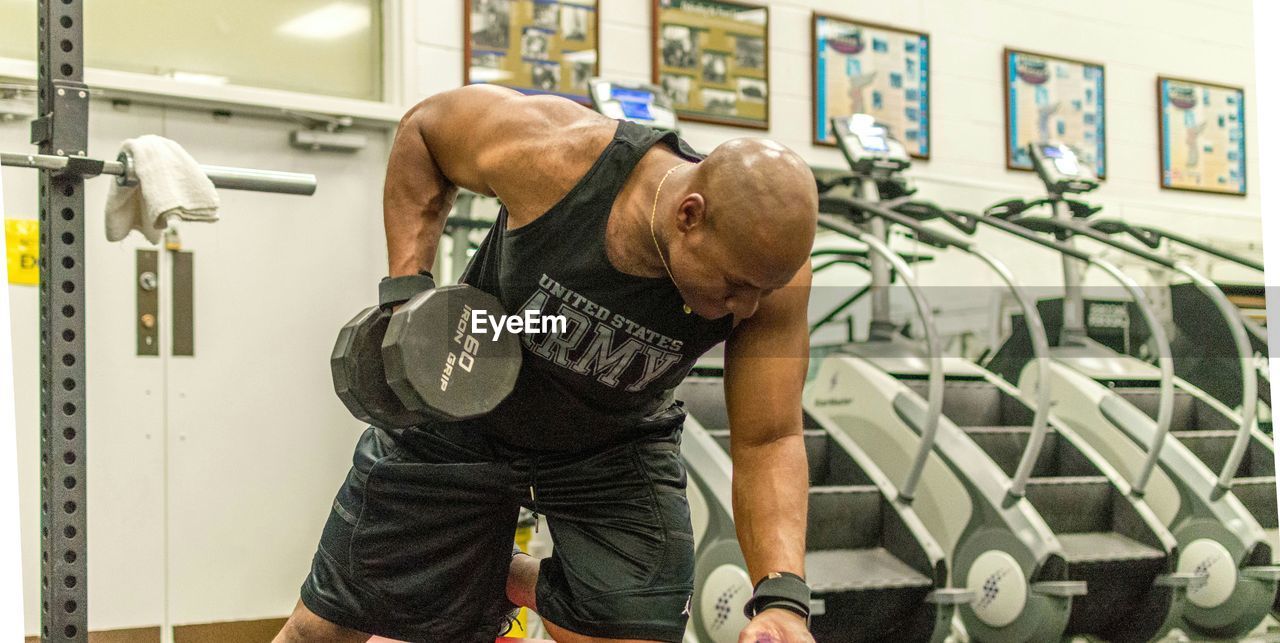 Man lifting dumbbells in gym