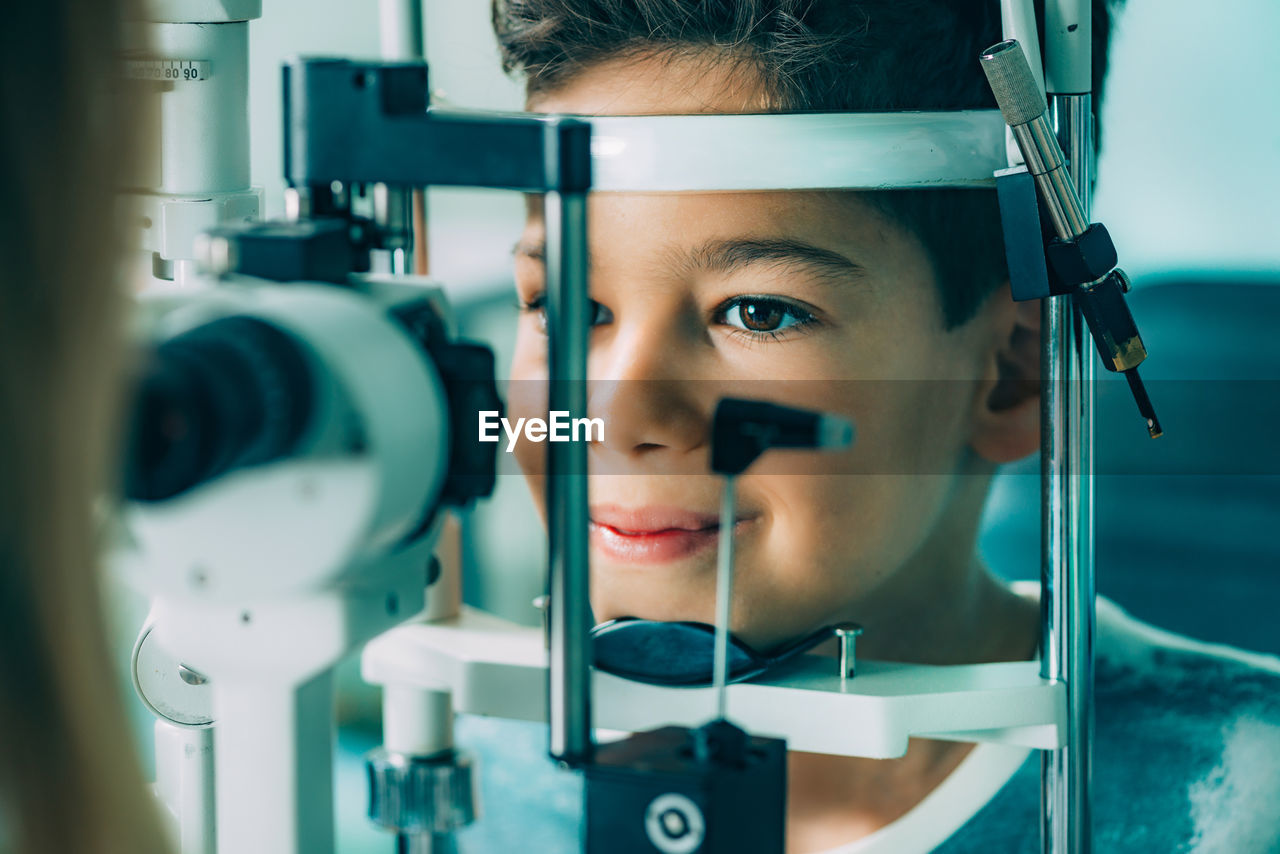 Close-up of ophthalmologist doing eye test of boy