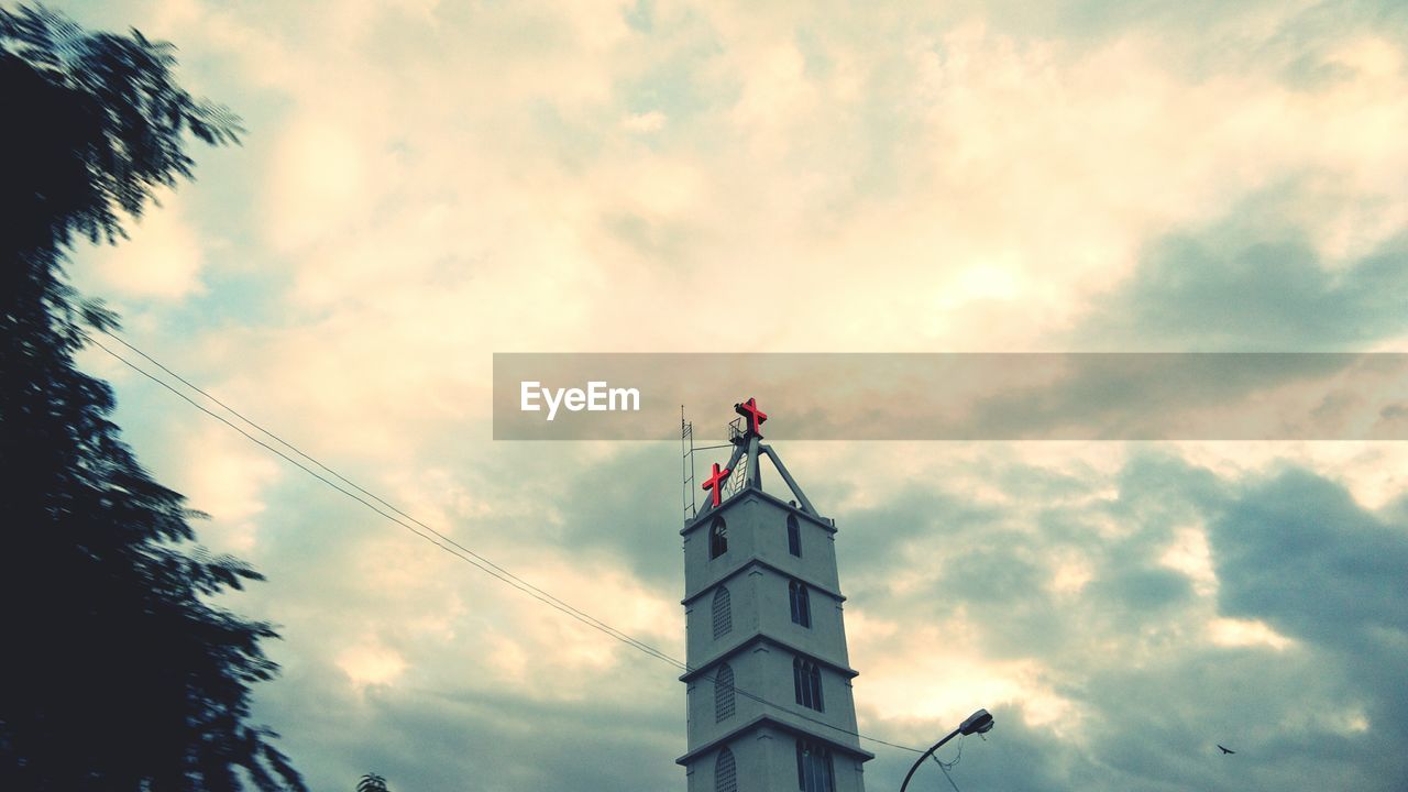 Low angle view of church against cloudy sky