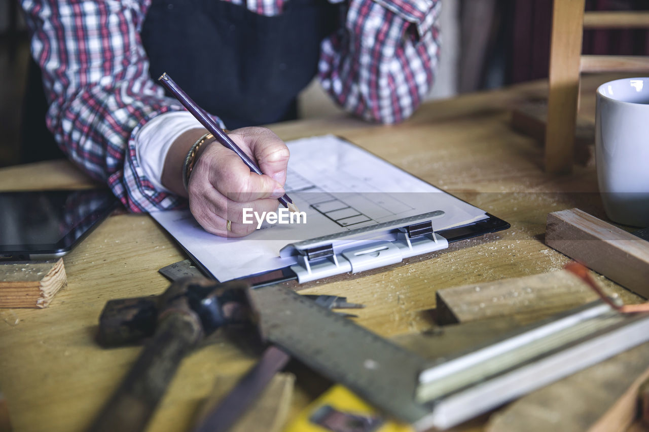 MAN WORKING AT TABLE