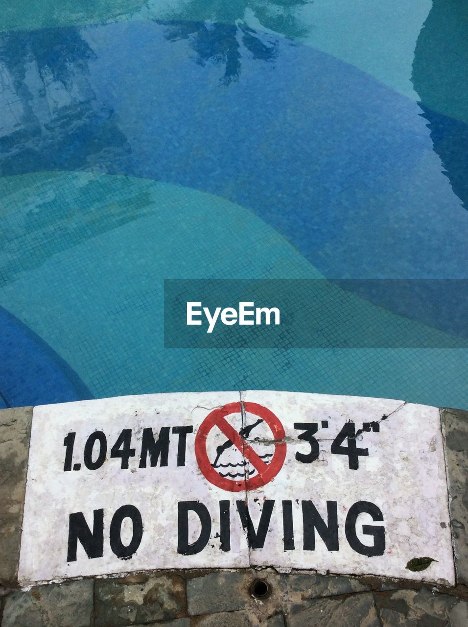 High angle view of warning sign by swimming pool