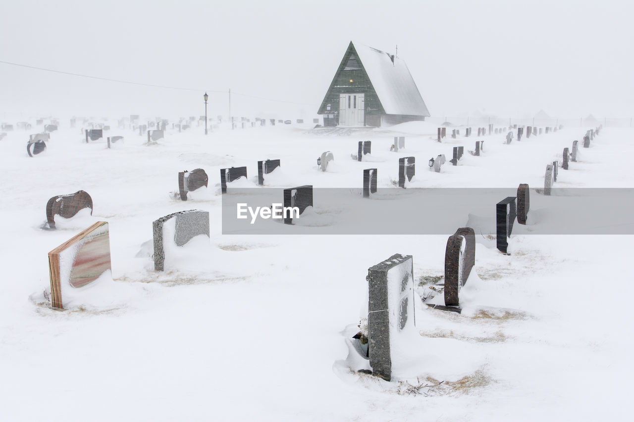 SNOW COVERED FIELD BY FENCE