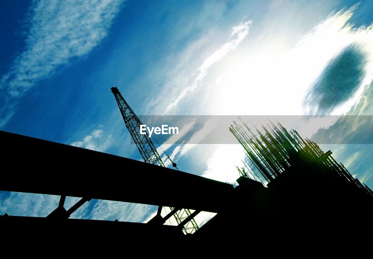 LOW ANGLE VIEW OF CRANES AGAINST SKY