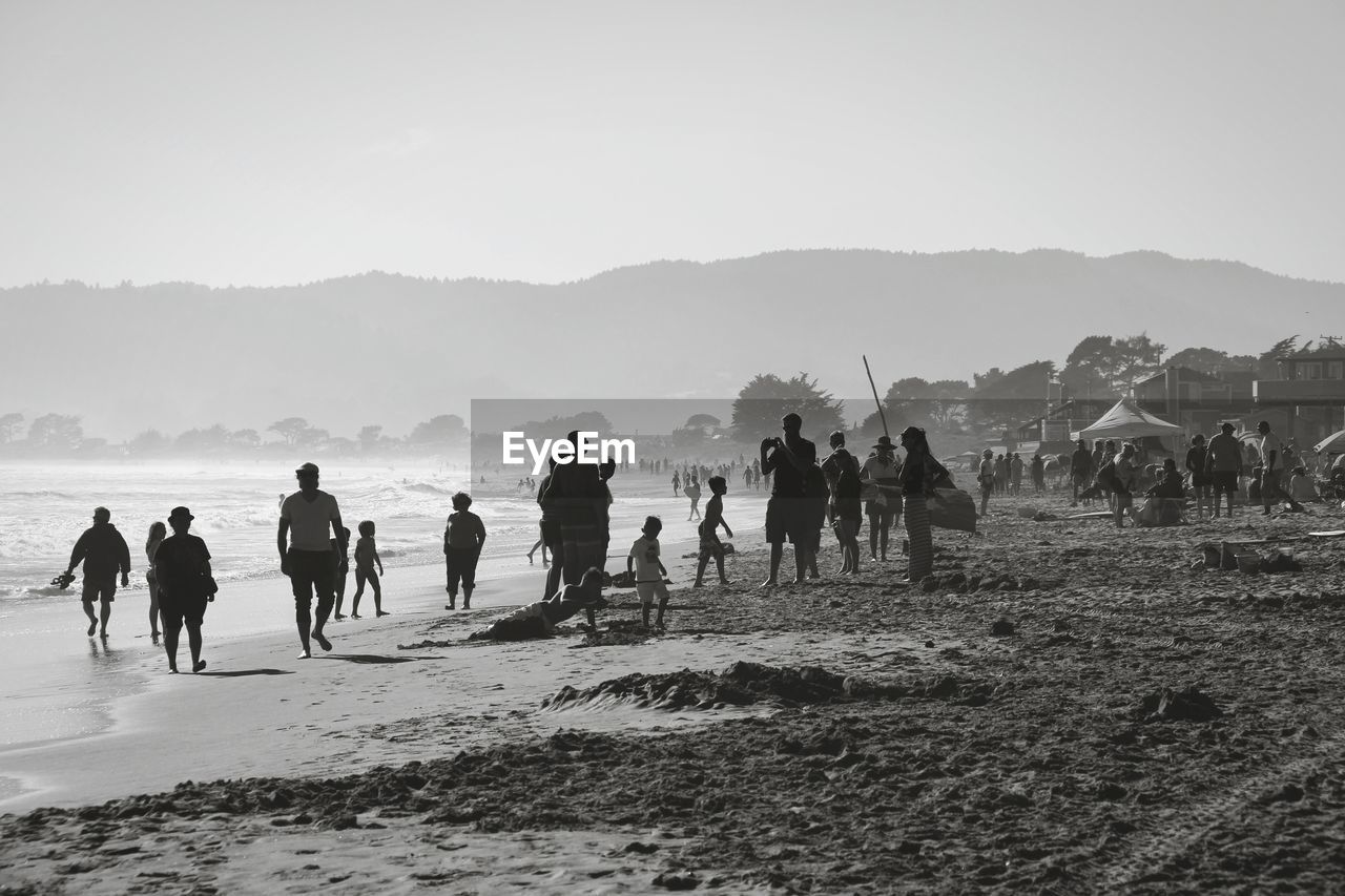 People at beach against sky