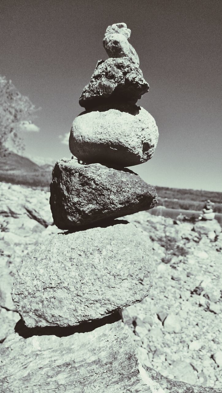 Low angle view of stack of pebbles during sunny day
