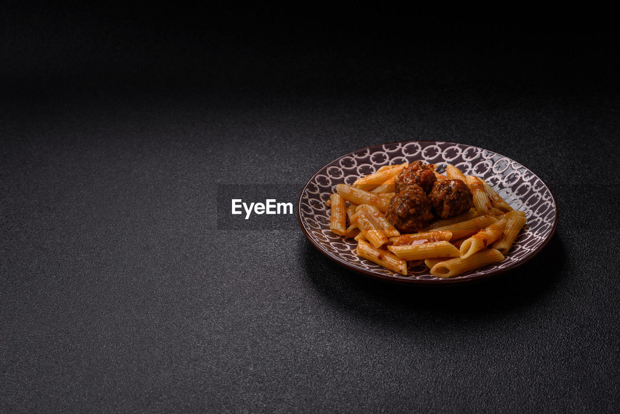 food and drink, food, studio shot, indoors, freshness, no people, copy space, black background, still life, snack, sweet food, plate, fast food, unhealthy eating, baked, produce, table, high angle view, fried, wellbeing, jewellery, sweet