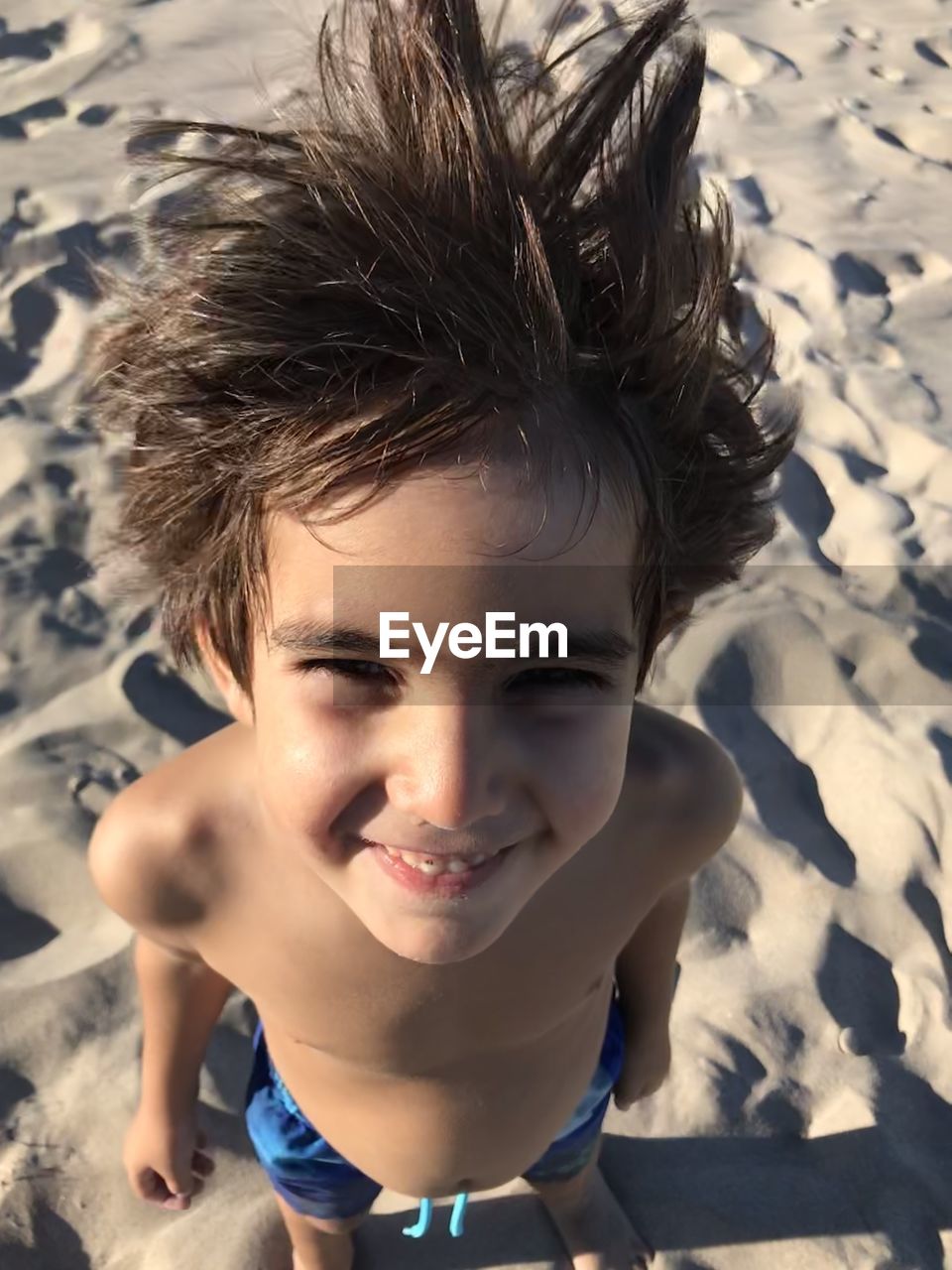 HIGH ANGLE PORTRAIT OF BOY SMILING