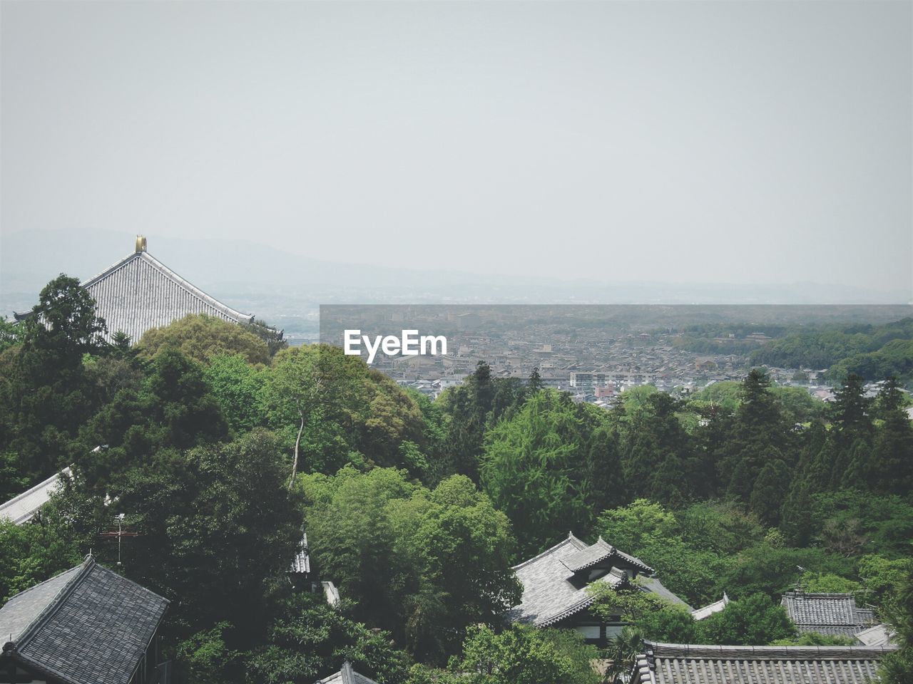 High angle view of houses and trees against clear sky