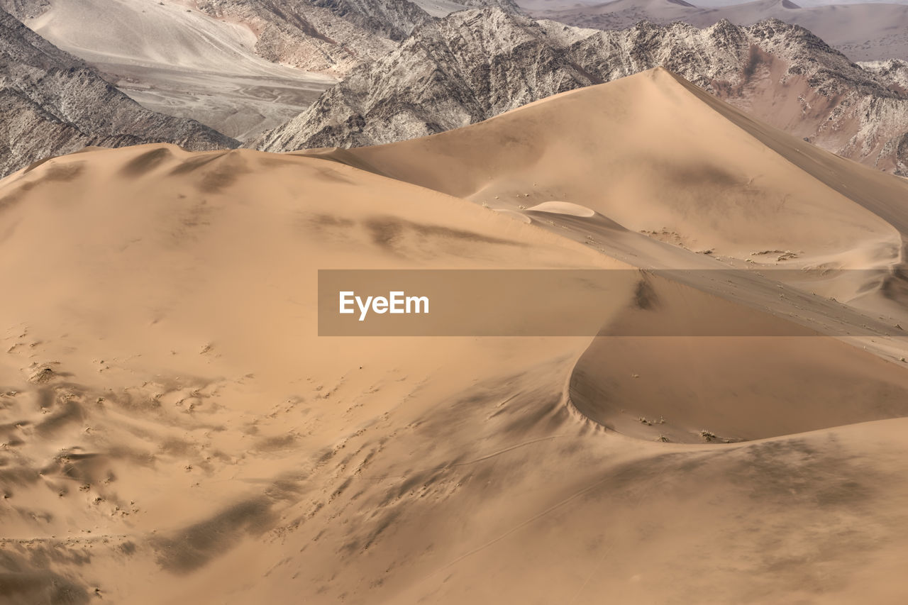 AERIAL VIEW OF SNOWCAPPED MOUNTAINS AGAINST SKY