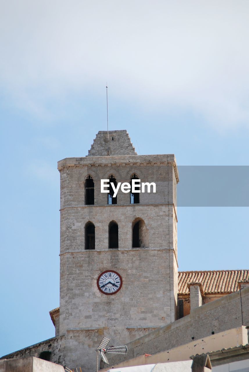 Low angle view of clock tower against sky