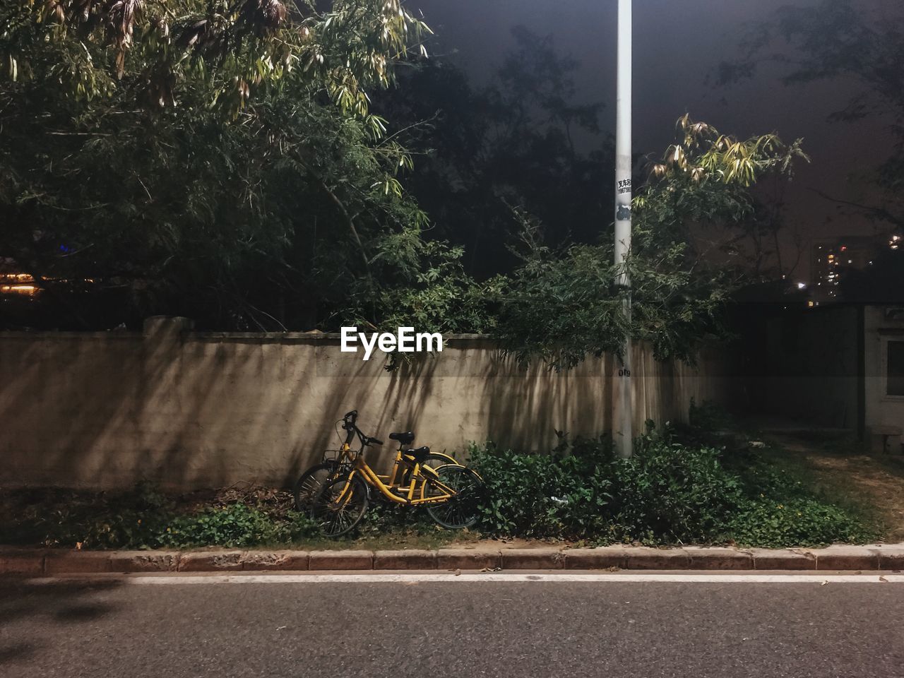 Bicycle parked on street at night