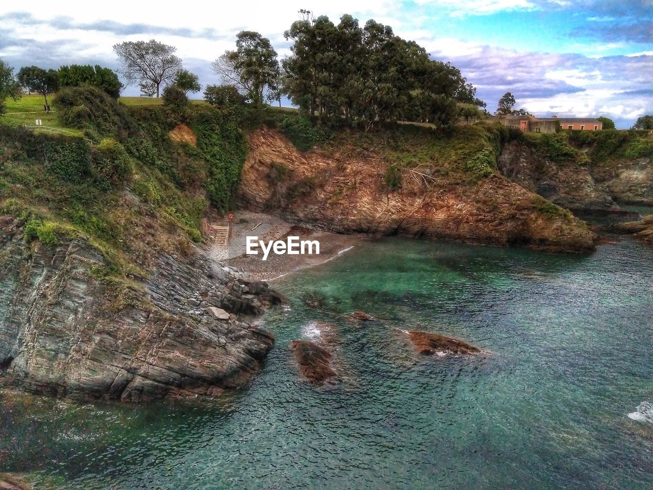 SCENIC VIEW OF LANDSCAPE BY WATER AGAINST SKY