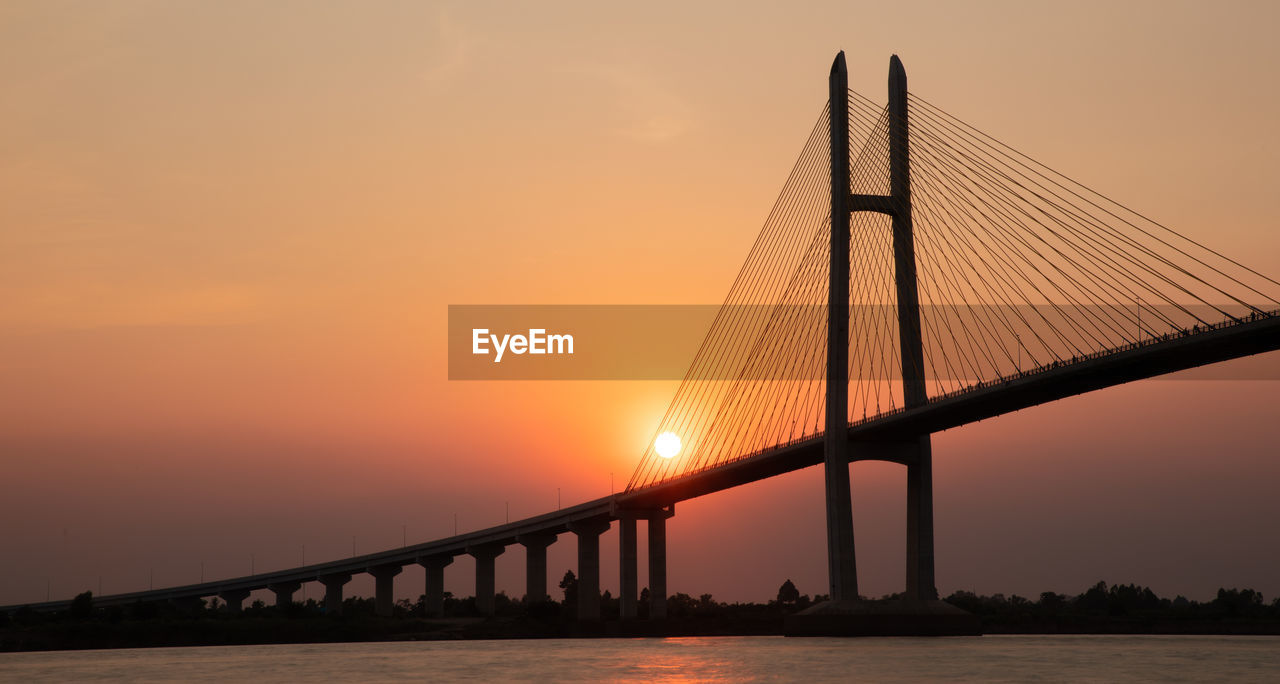 Low angle view of bridge against sky during sunset