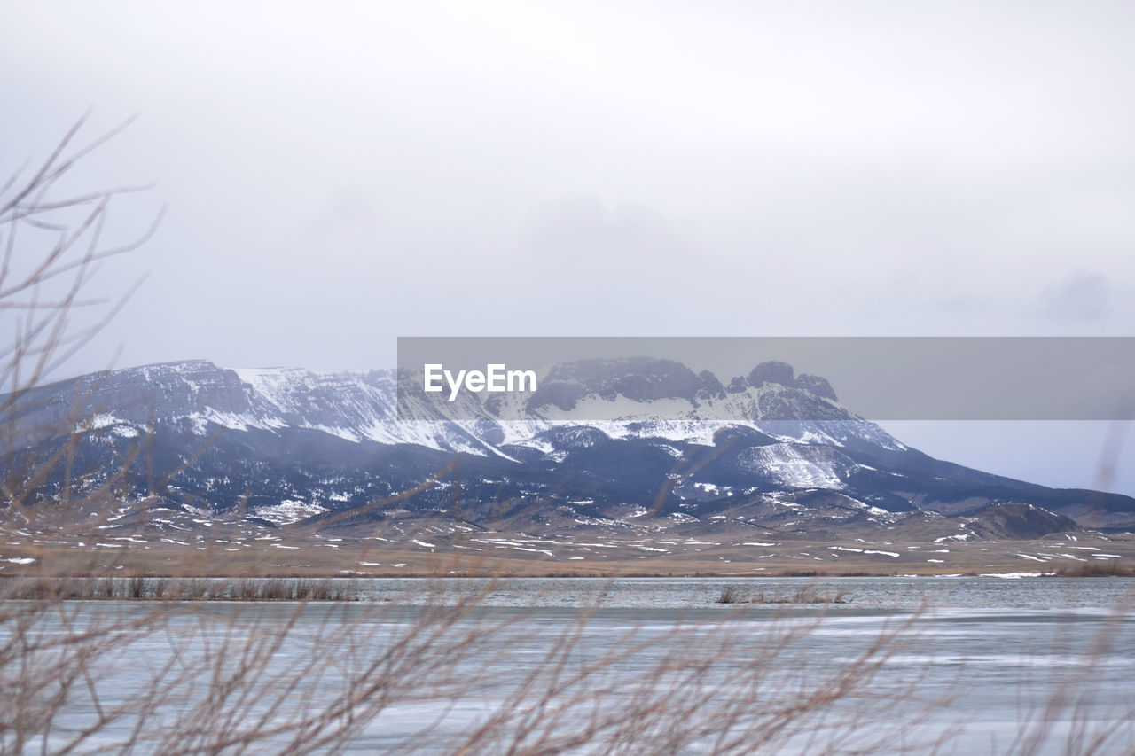 SCENIC VIEW OF MOUNTAINS AGAINST SKY DURING WINTER