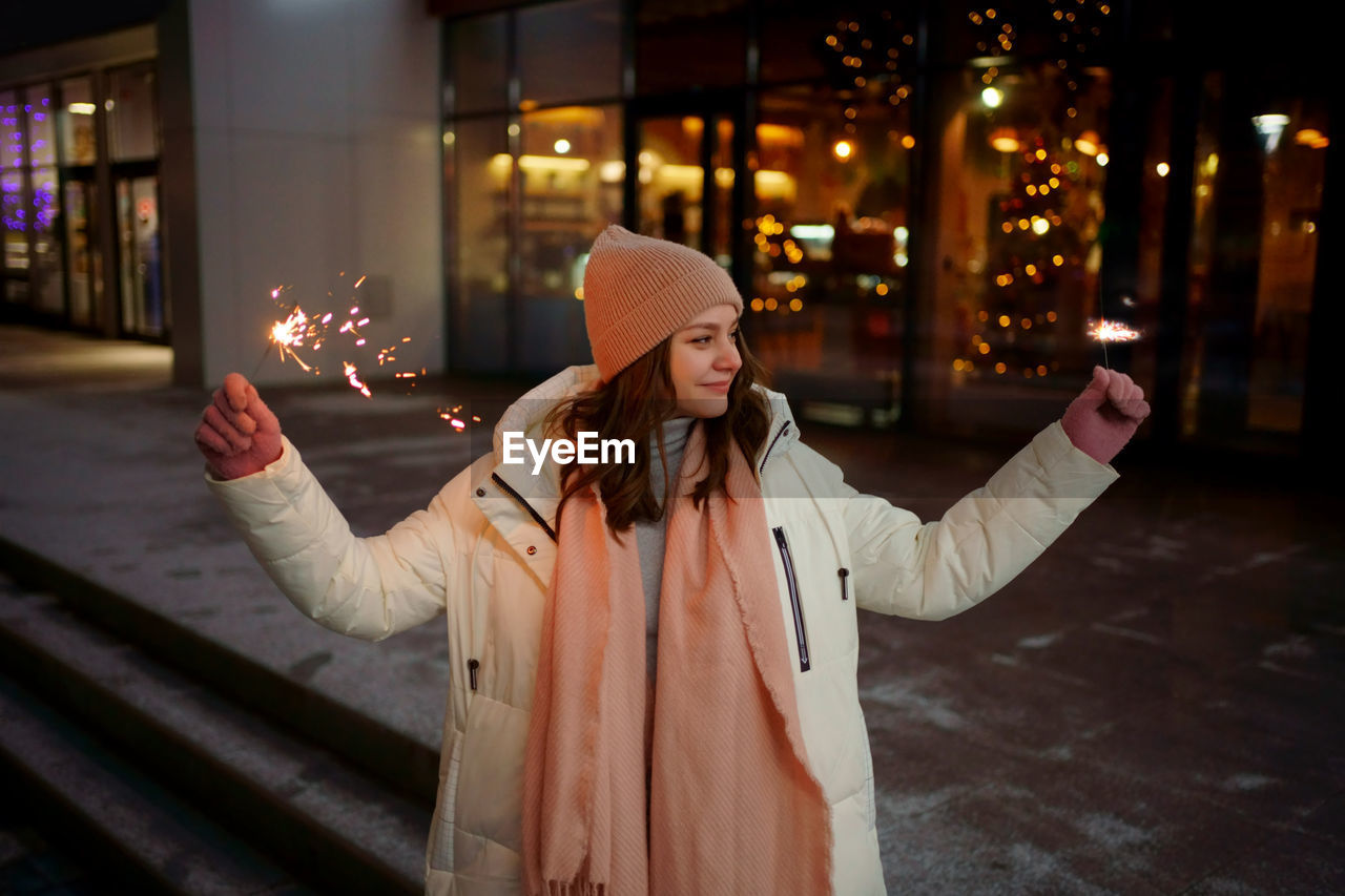 Caucasian white girl with sparklers christmas shopping