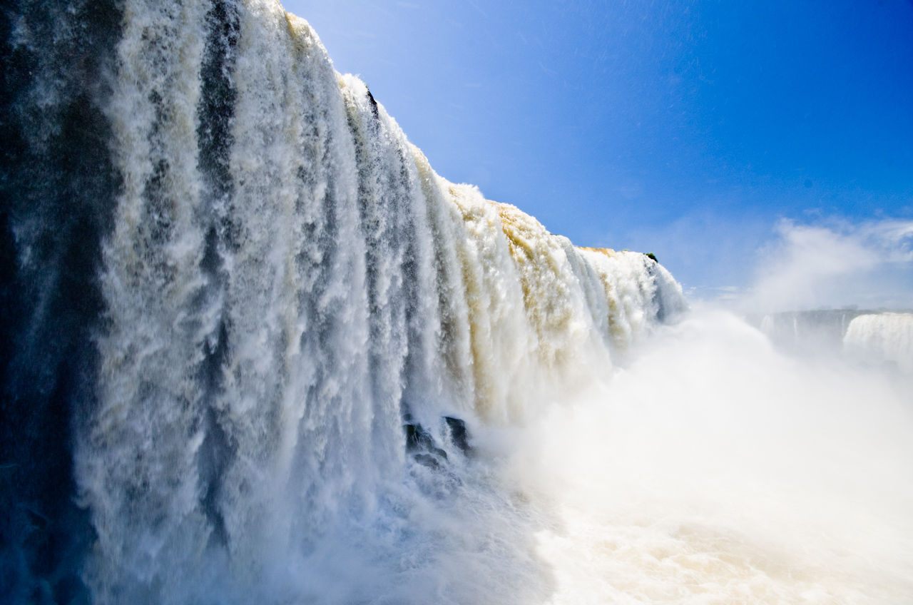 Low angle view of waterfall against clear sky