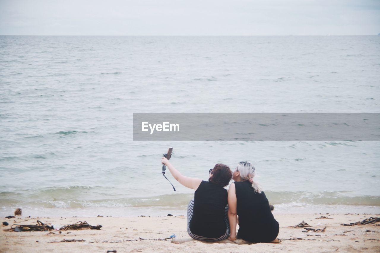 Friends taking selfie at beach