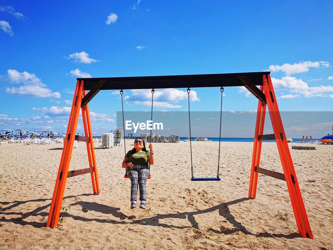 REAR VIEW OF PEOPLE ON BEACH