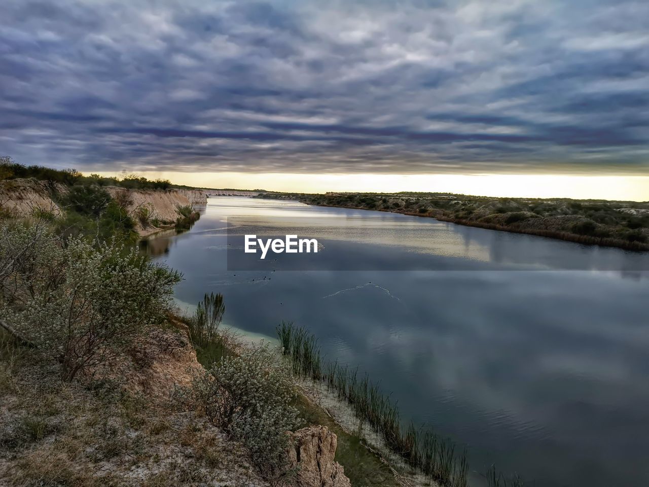 SCENIC VIEW OF LAKE BY TREES AGAINST SKY