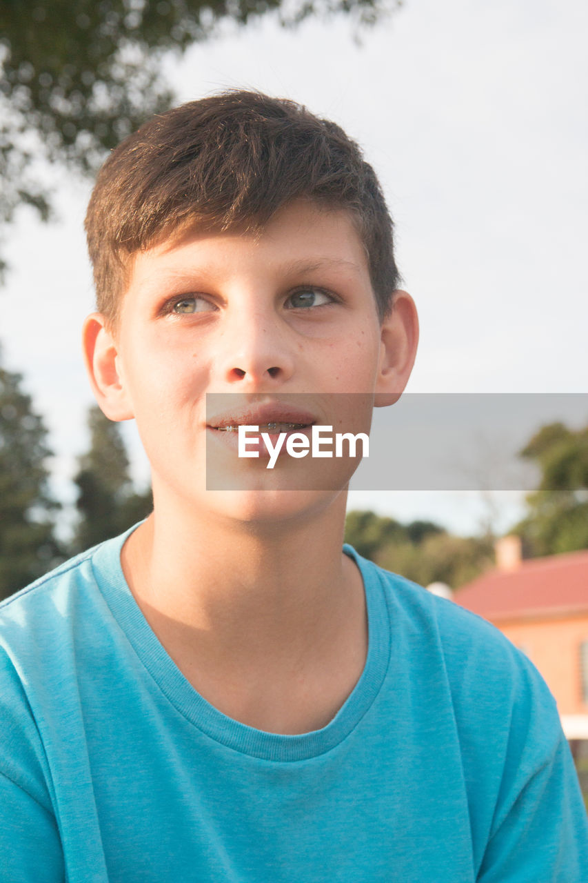 PORTRAIT OF BOY WITH MAN IN BACKGROUND