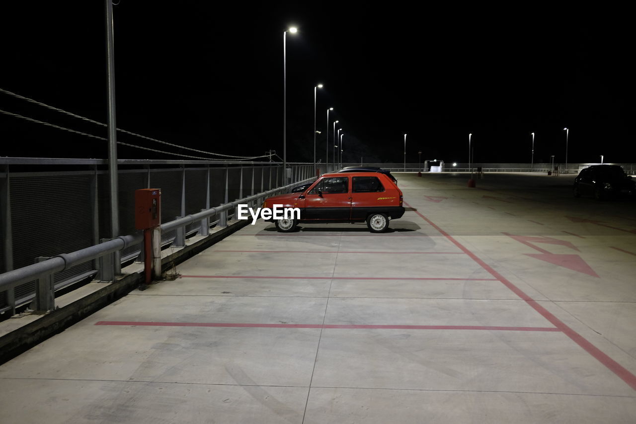 CAR ON ILLUMINATED STREET