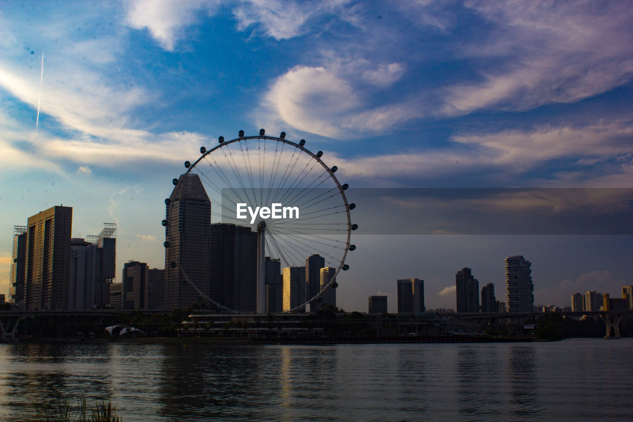 VIEW OF FERRIS WHEEL AGAINST BUILDINGS