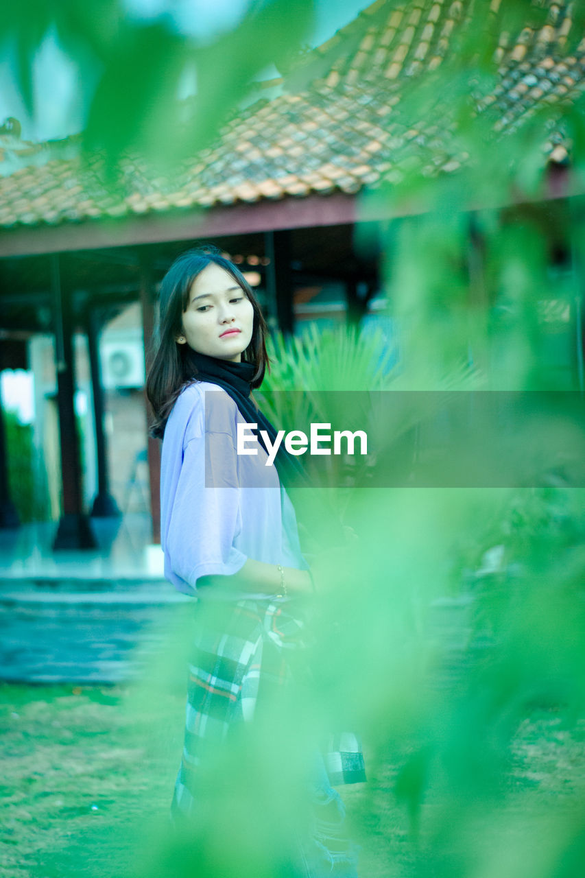 Young woman standing infront of traditional house of yogyakarta