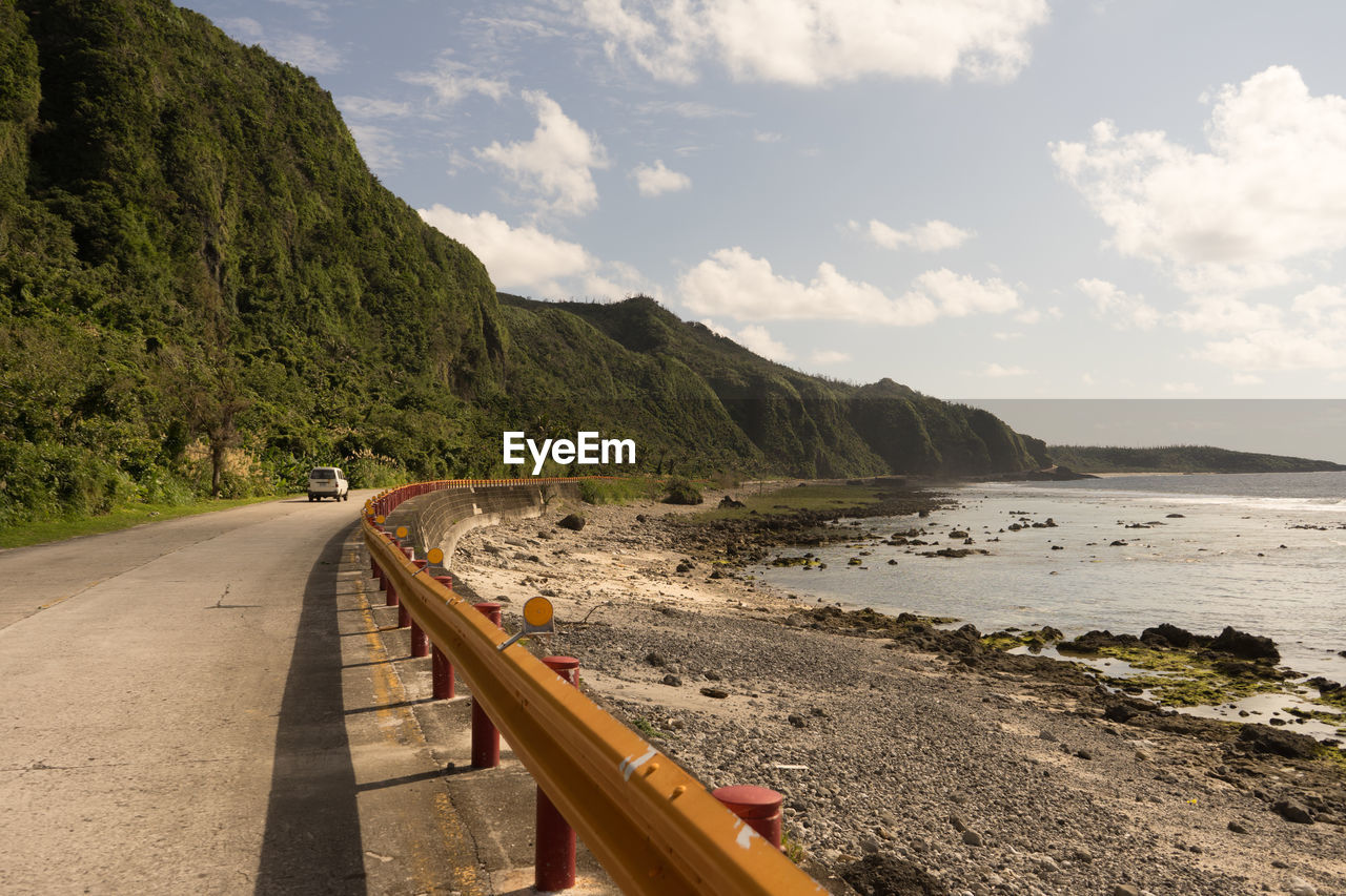 Scenic view of sea and mountains against sky