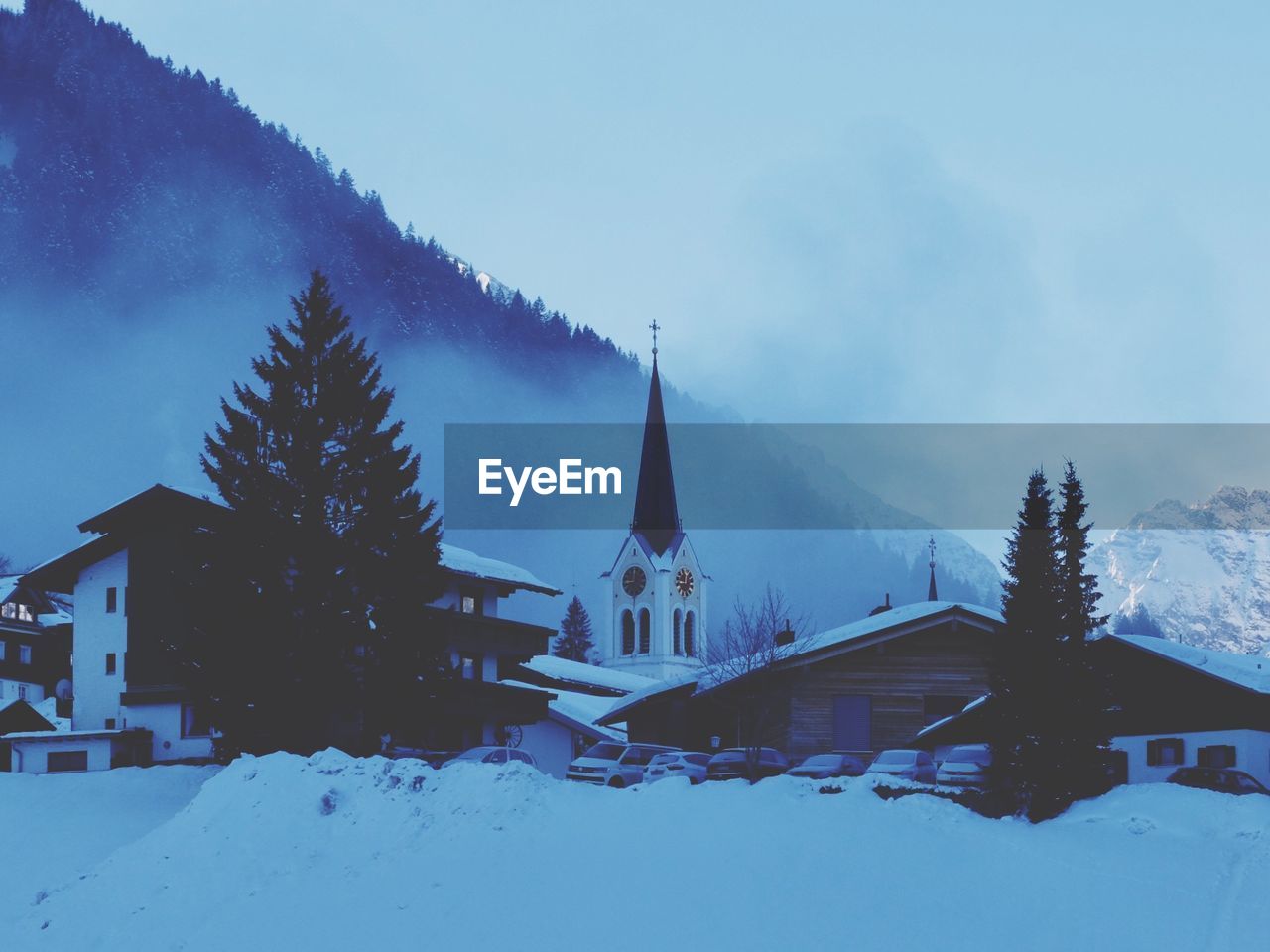 Houses against sky during winter