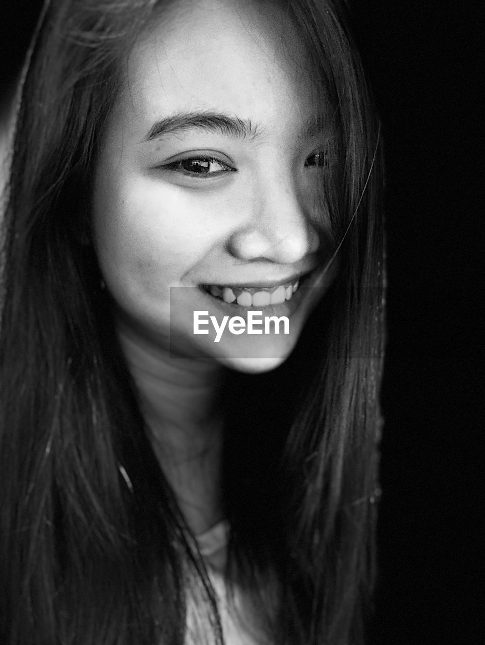 Close-up portrait of smiling young woman