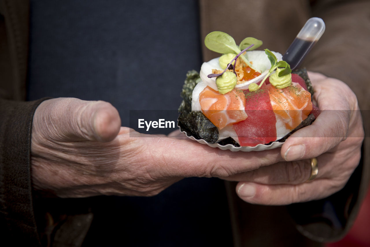 Midsection of man holding food 