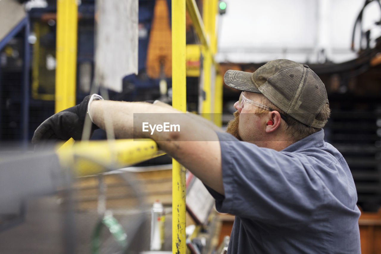 Side view of worker in steel industry factory