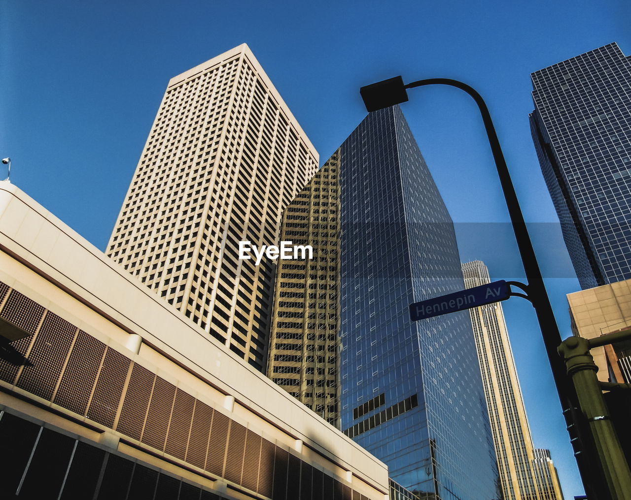 Low angle view of skyscrapers against clear blue sky