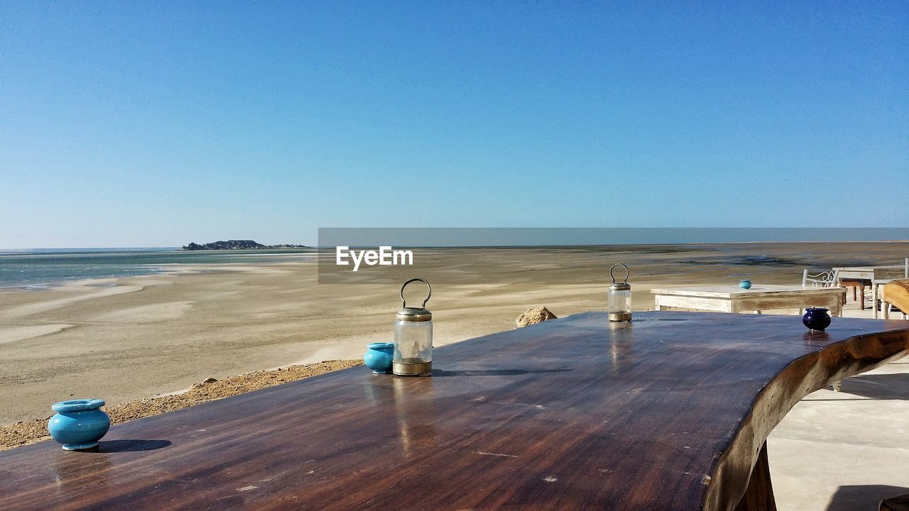 Scenic view of beach against clear blue sky