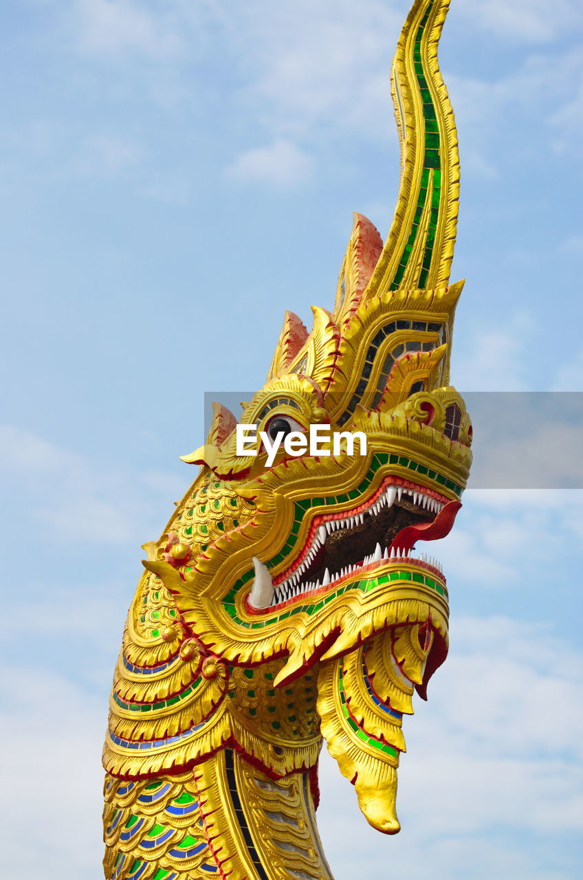 Dragon head on sky background.