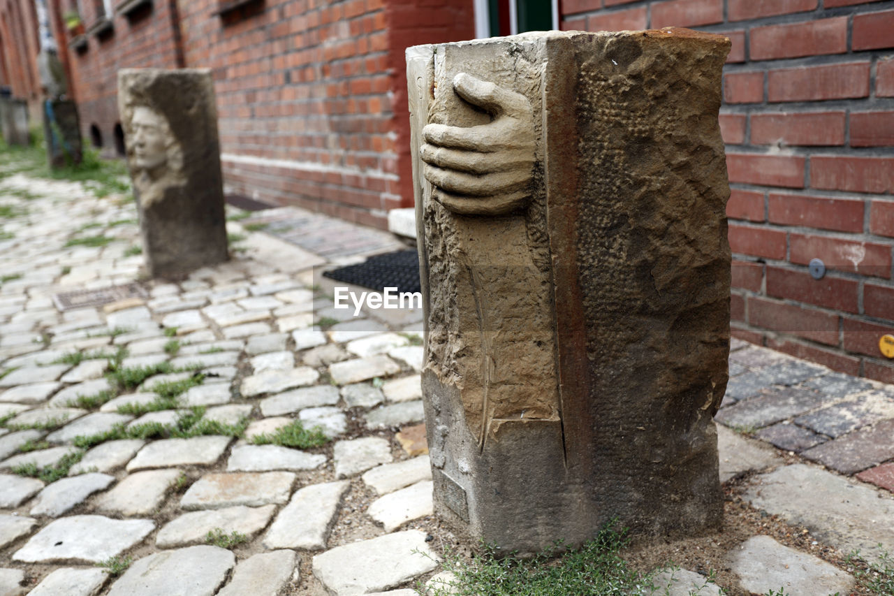 Sculptures on cobblestone street