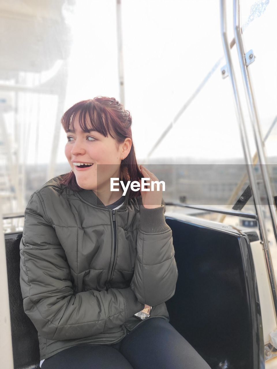 Portrait of young woman on a ferris wheel