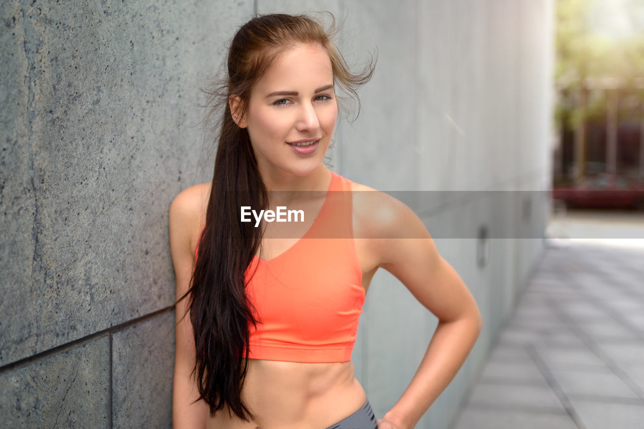 Portrait of young woman in sports clothing