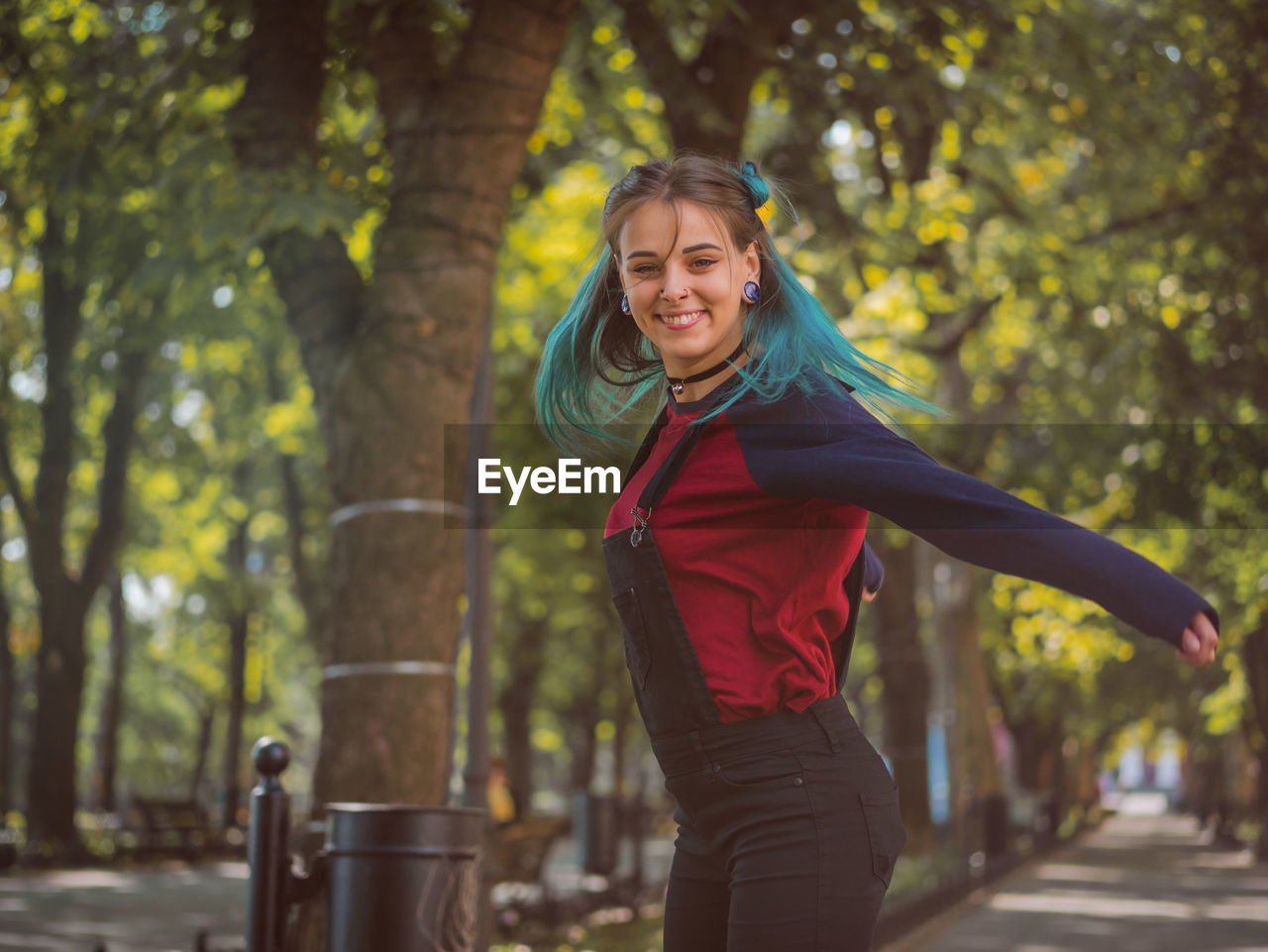 Portrait of smiling young woman enjoying at park