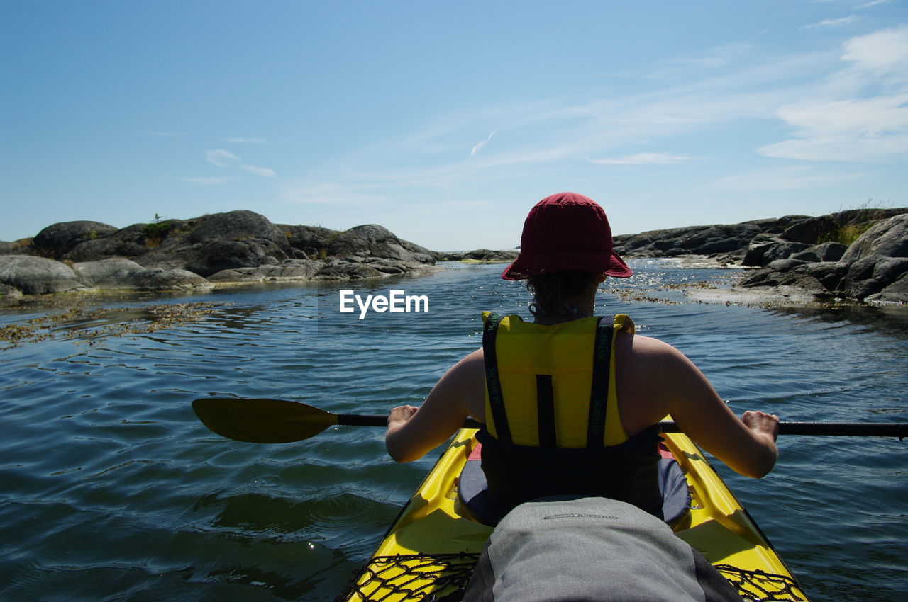 Rear view of man sitting in kayak