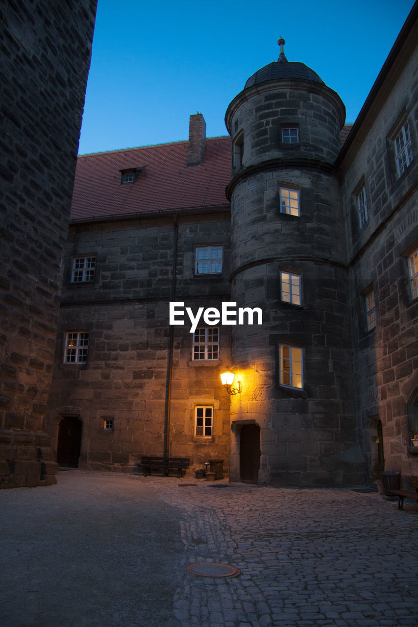 ILLUMINATED BUILDINGS IN CITY AT NIGHT