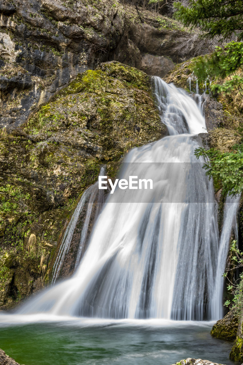 waterfall, beauty in nature, water, scenics - nature, nature, environment, motion, body of water, plant, land, rock, forest, tree, watercourse, stream, no people, flowing water, water feature, outdoors, long exposure, travel destinations, flowing, non-urban scene, landscape, river, autumn, travel, blurred motion, tourism, idyllic, water resources, speed