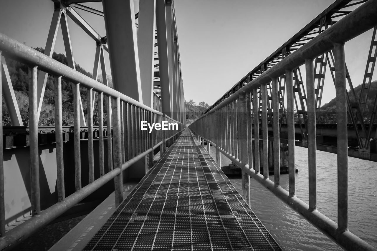 FOOTBRIDGE OVER WATER AGAINST SKY