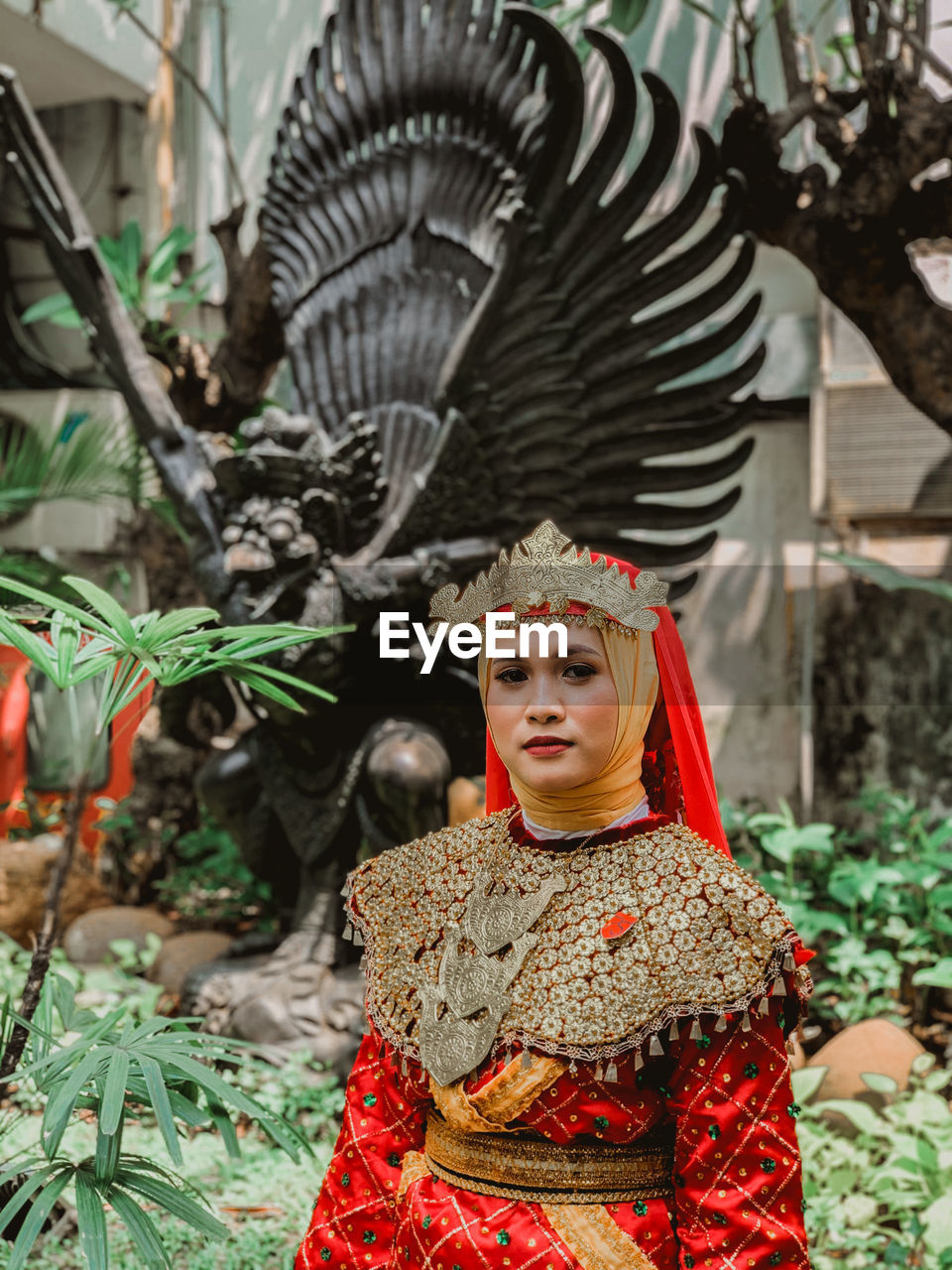 Portrait of young woman in costume standing outdoors