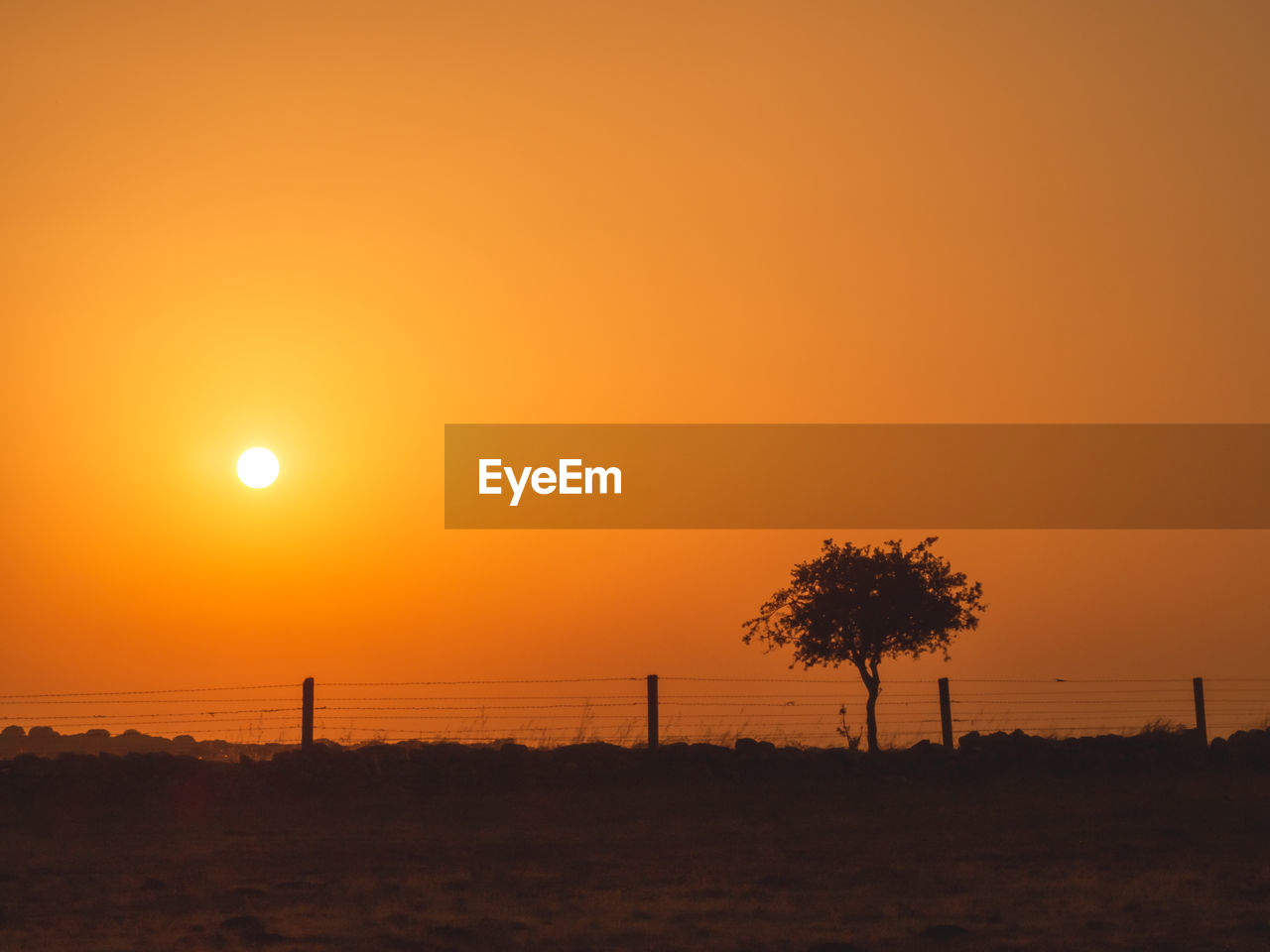 SCENIC VIEW OF SILHOUETTE LANDSCAPE AGAINST ORANGE SKY