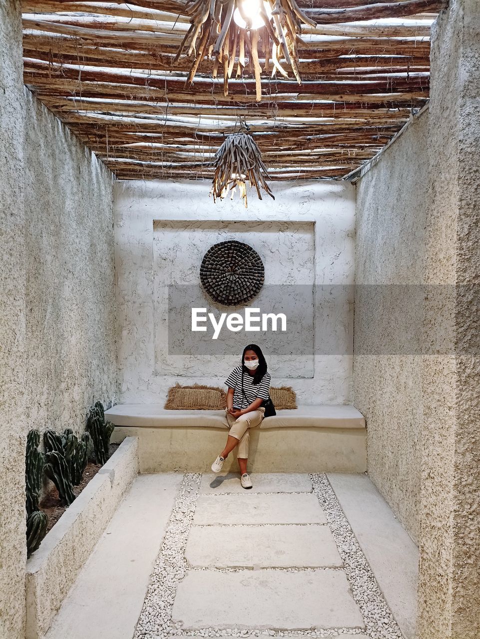 Low angle view of woman sitting on staircase