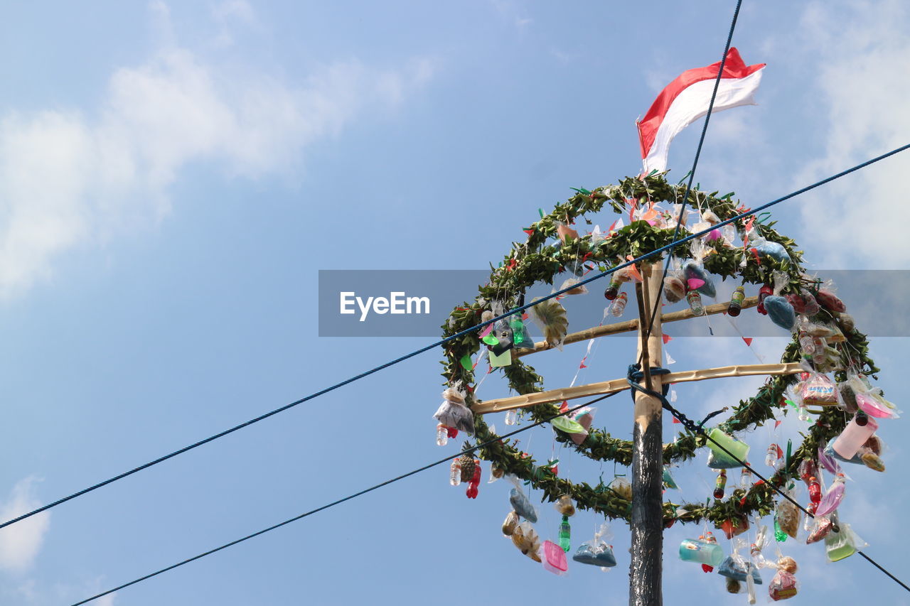 LOW ANGLE VIEW OF DECORATION HANGING AGAINST SKY