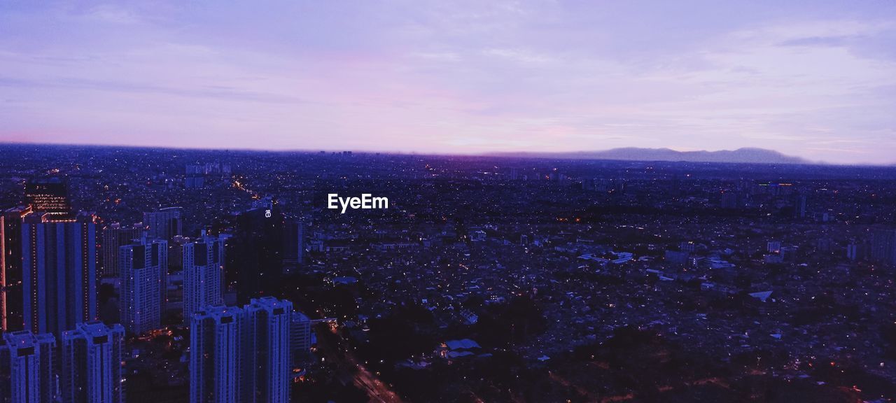 Aerial view of cityscape against sky