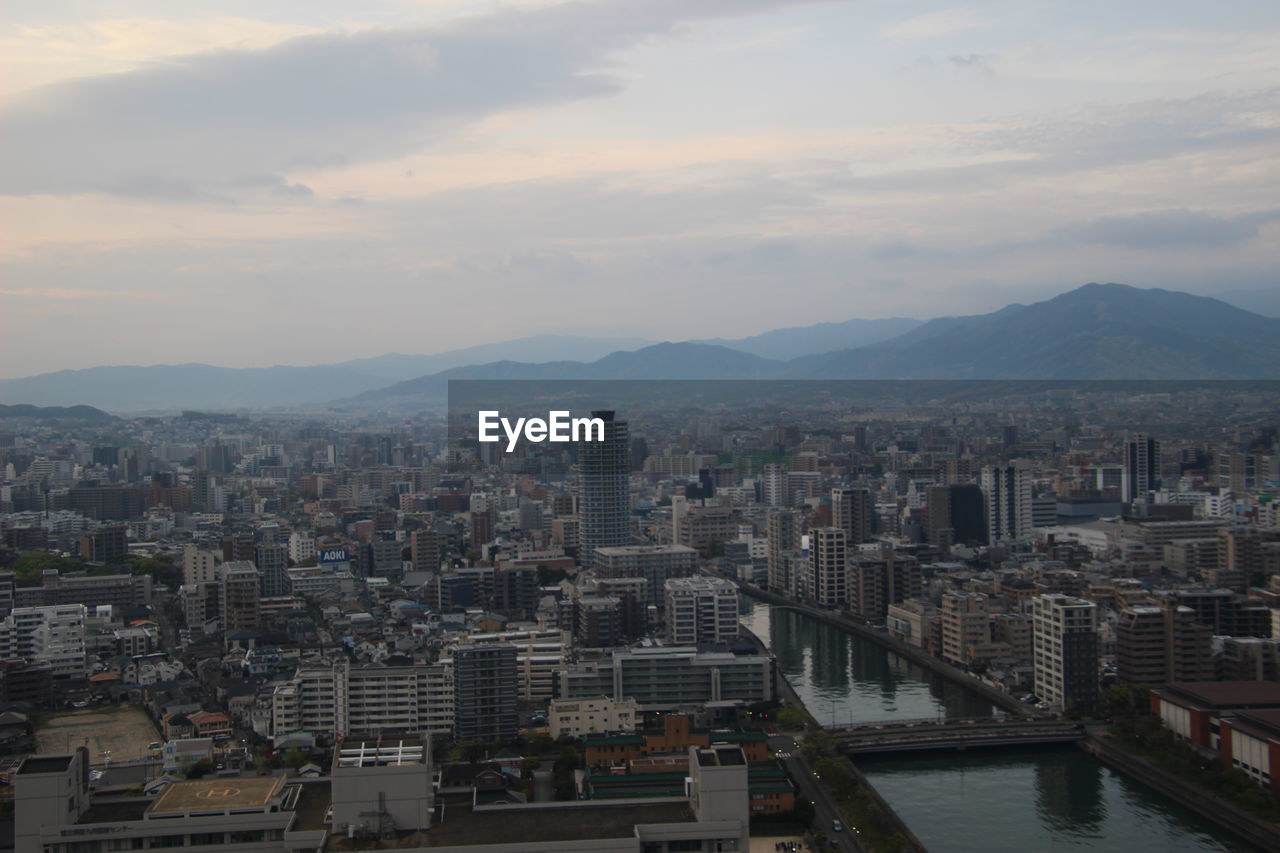 High angle view of buildings in city against sky during sunset